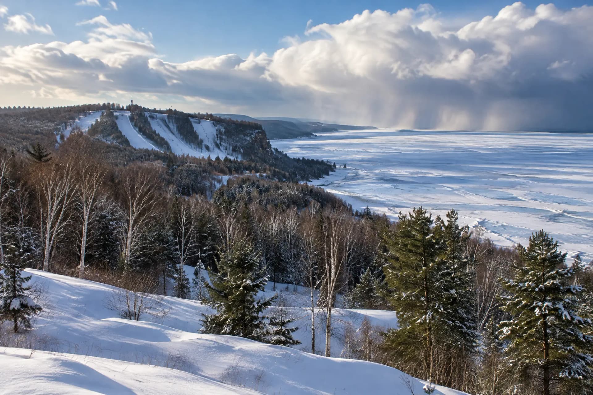 Snowy hills above a frozen Great Lakes shoreline
